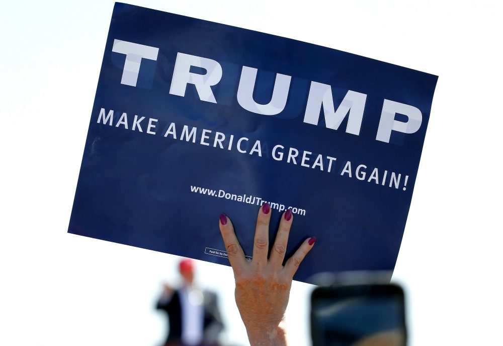 In this March 19, 2016 photo, a supporter holds a sign as Republican presidential candidate Donald Trump speaks during a campaign rally in Fountain Hills, Ariz. (Matt York/AP)