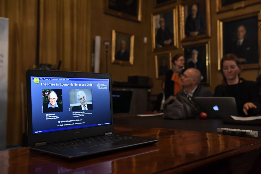 British-American economist Oliver Hart (left) and Bengt Holmstrom of Finland, are displayed on a screen during a press conference to announce the winner of the 2016 Nobel Prize in Economic Sciences at the Royal Swedish Academy of Sciences in Stockholm on Oct. 10, 2016. (Jonathan Nackstrand/AFP/Getty Images)