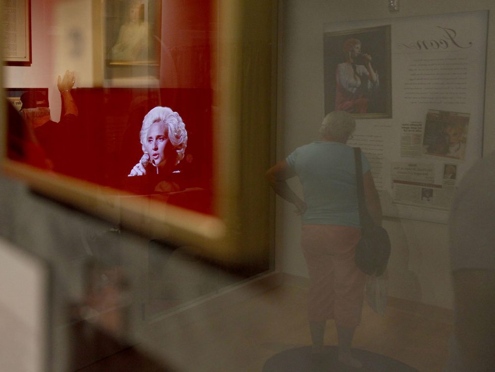 In this Sept. 15, 2010 photo, a video of Tammy Wynette is reflected in a glass case at the Tammy Wynette exhibit at The Country Music Hall of Fame in Nashville, Tenn. (Josh Anderson/AP)