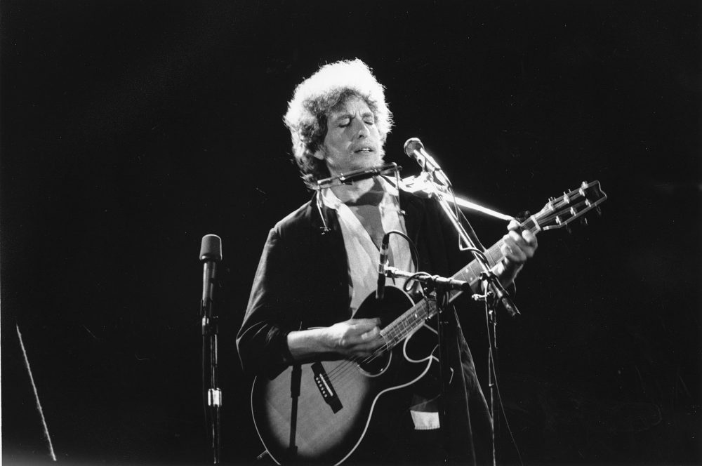Singer-songwriter Bob Dylan performing onstage with his acoustic guitar and harmonica. (AP)