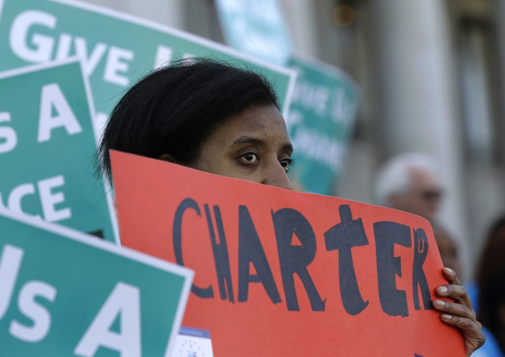 Lavinda Trammell, of Tacoma, Wash., who said she is a parent of a child that attends a charter school, holds a sign during a rally in support of public charter schools at the Capitol in Olympia, Wash. on Feb. 25, 2016. (Ted S. Warren/AP)