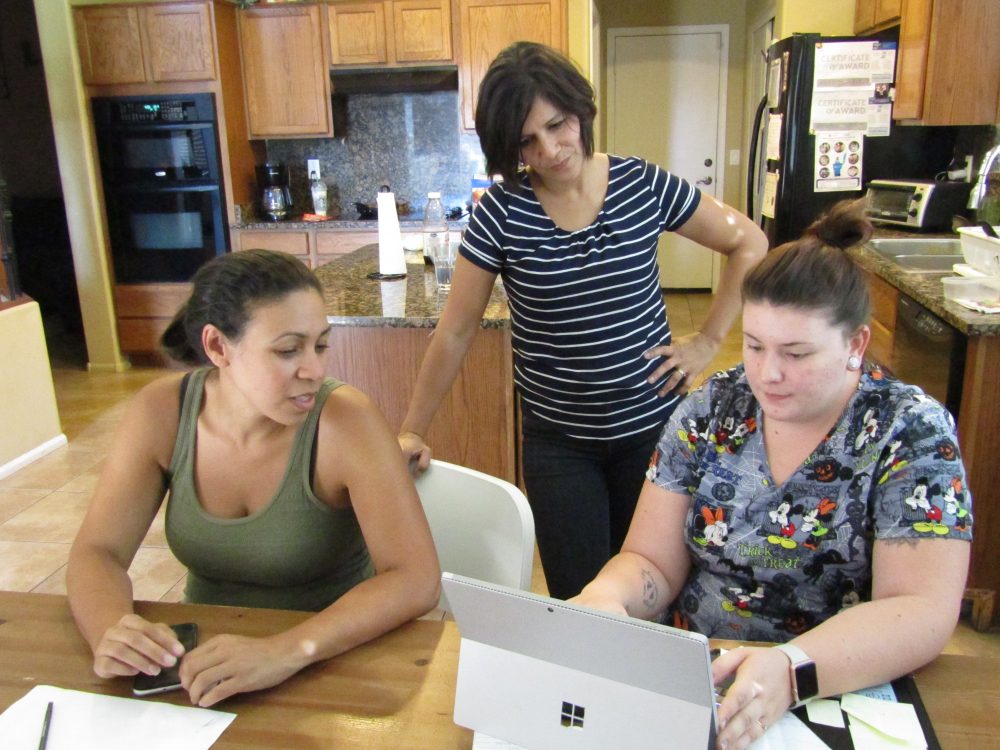 Jennifer Redmond (left, in green shirt) runs a group home for LGBT teens in Arizona. (Casey Kuhn/KJZZ)