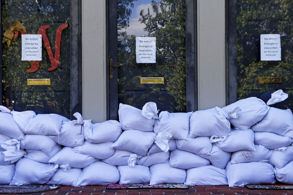 Sandbags and no entry signs are seen in front of apartments located near the Tar River as floodwaters associated with Hurricane Matthew continue to rise on Wednesday, Oct. 12, 2016, in Greenville, N.C. The city is about half an hour south of Princeville, N.C. (Brian Blanco/AP)