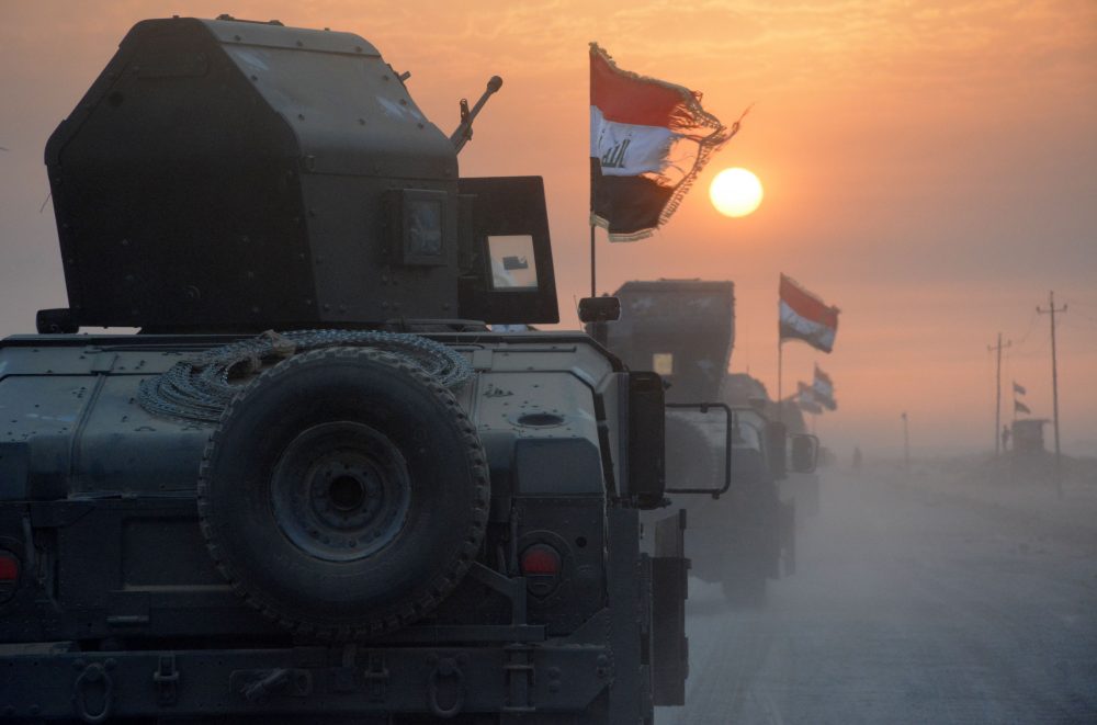 Pro-government forces drive in military vehicles in Iraq's eastern Salaheddin province, south of Hawijah, on Oct. 10, 2016, as they clear the area in preparation for the push to retake the northern Iraqi city of Mosul, the last Islamic State (IS) group-held city in Iraq. (Mahmoud Al-Samarrai/AFP/Getty Images)