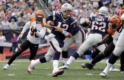 New England Patriots quarterback Tom Brady runs from Cincinnati Bengals defensive end Michael Johnson during the first half of Sunday's games. (Elise Amendola/AP)