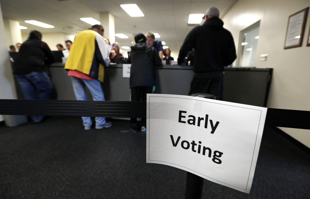 Local residents receive their ballots at the Polk County Election Office on the first day of early voting in Des Moines, Iowa, on Sept. 29, 2016. (Charlie Neibergall/AP)