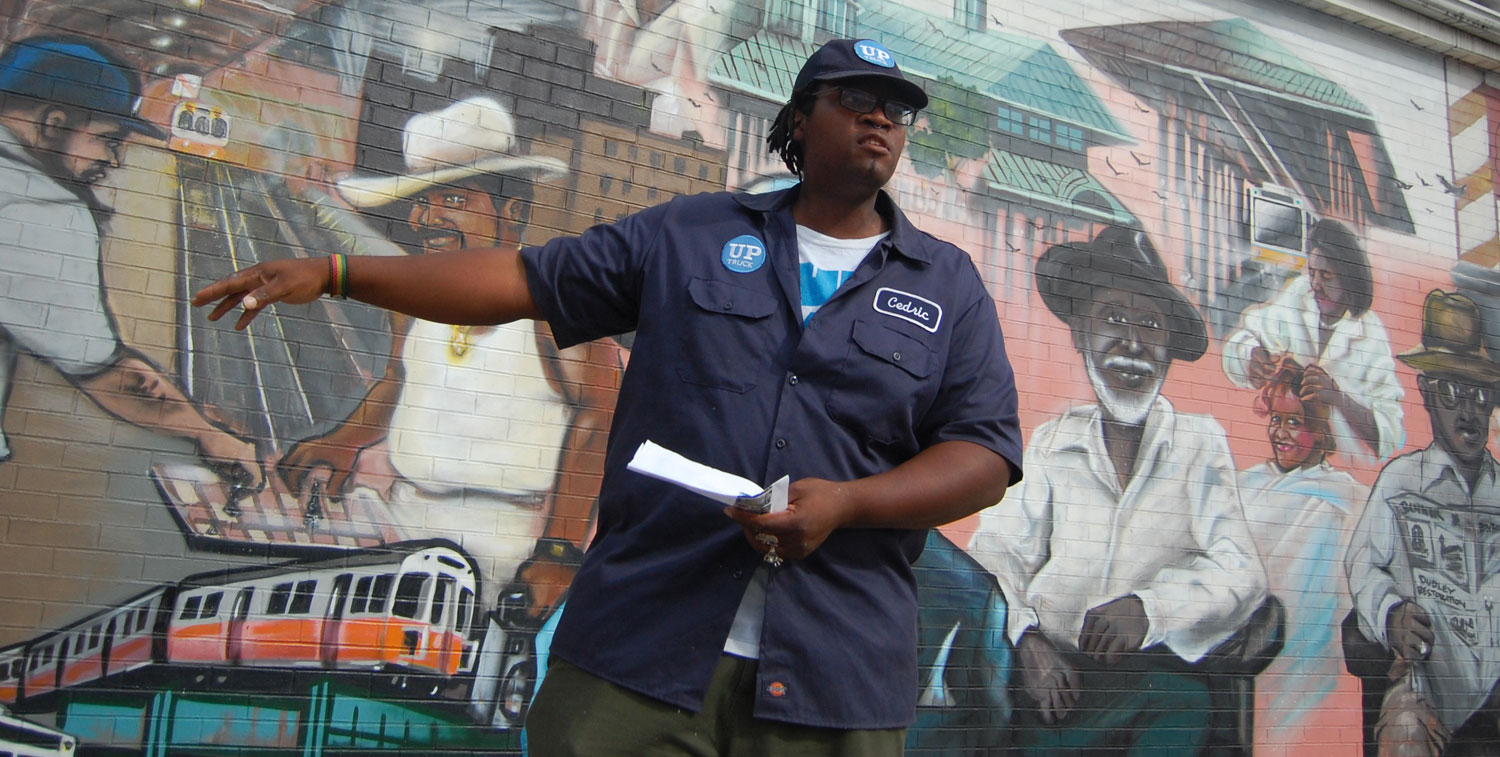 Cedric Douglas at the &quot;Faces of Dudley&quot; mural in Roxbury. (Greg Cook)