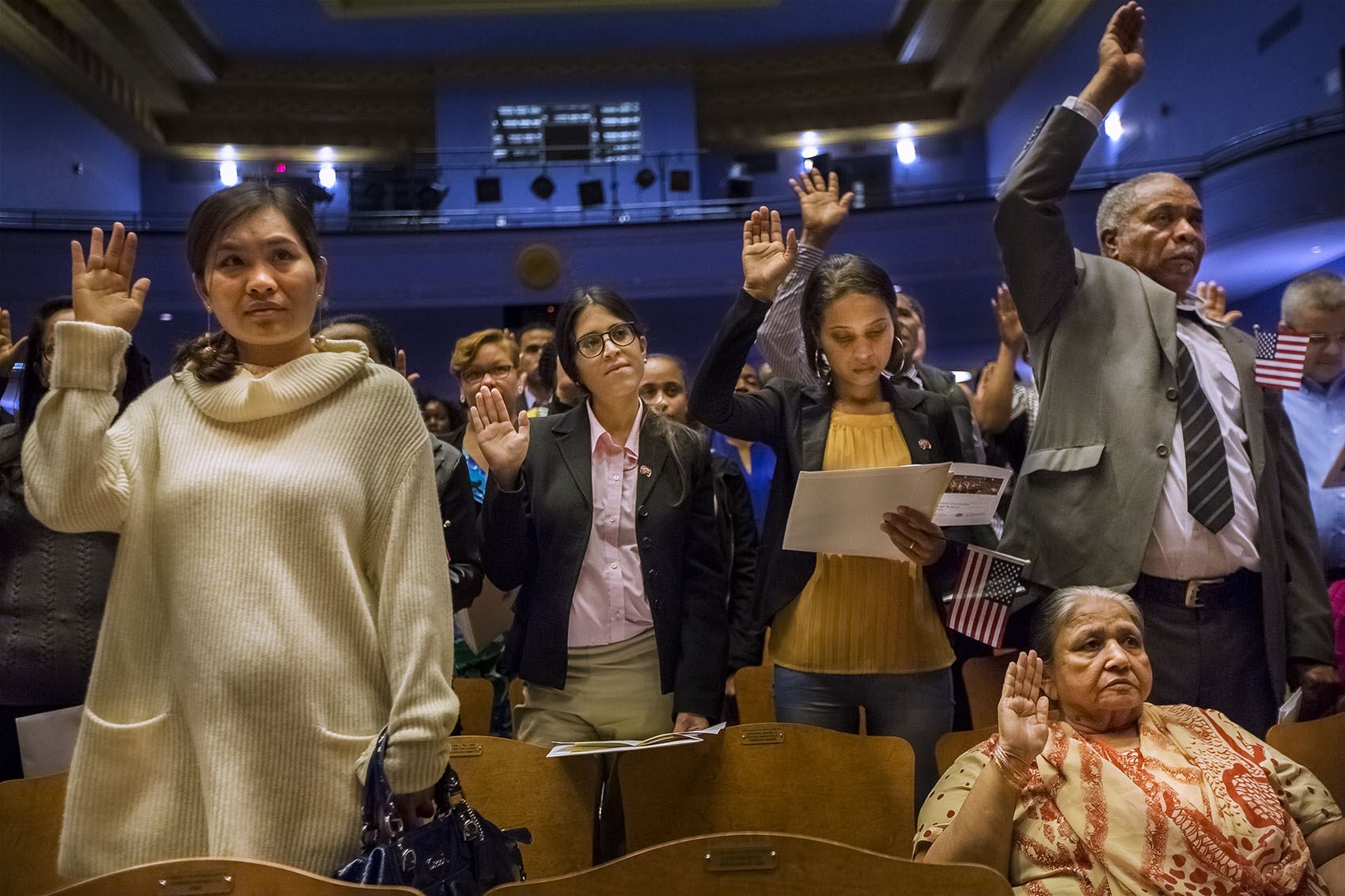 Close to 150 naturalization applicants took the Oath of Allegiance during a ceremony at Jenkins Auditorium at Malden High School on Oct. 18. (Jesse Costa/WBUR)