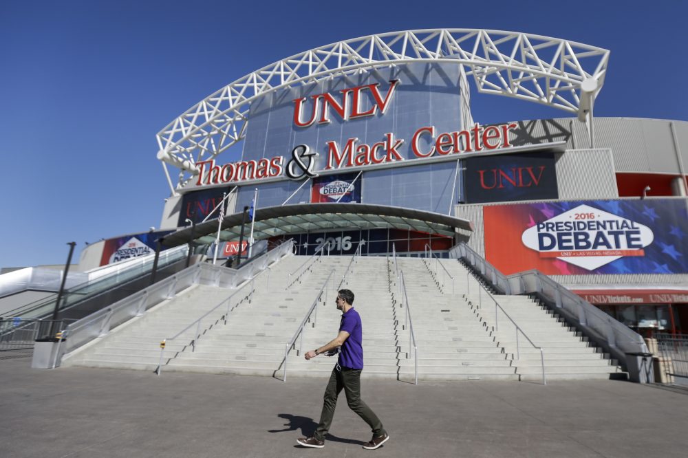 A pedestrian walks past the site for the third presidential debate between Republican presidential nominee Donald Trump and Democratic presidential nominee Hillary Clinton at UNLV in Las Vegas on Tuesday. (Julio Cortez/AP)