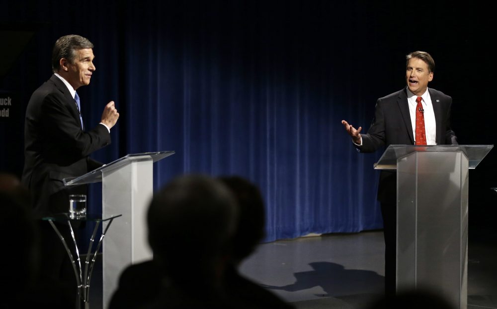 Democratic gubernatorial candidate Attorney General Roy Cooper, left, and North Carolina Republican Gov. Pat McCrory participate in a live televised debate at UNC-TV studios in Research Triangle Park, N.C., Tuesday, Oct. 11, 2016. (Gerry Broome, Pool/AP)