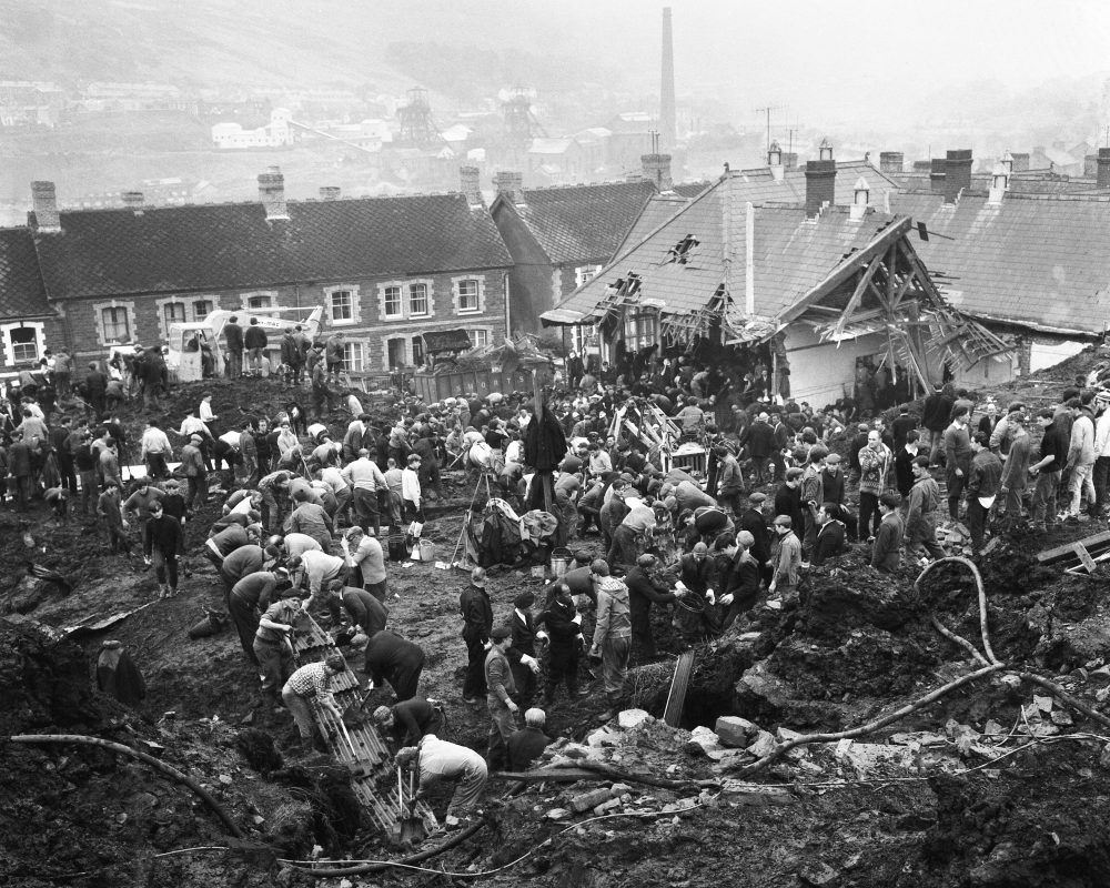 In this Oct. 22, 1966 file photo, rescue workers shovel the wet coal waste 28 hours after it slipped down the man-made mountain of coal waste and engulfed the Pantglas Junior School, and some houses, in Aberfan, Wales. (AP)