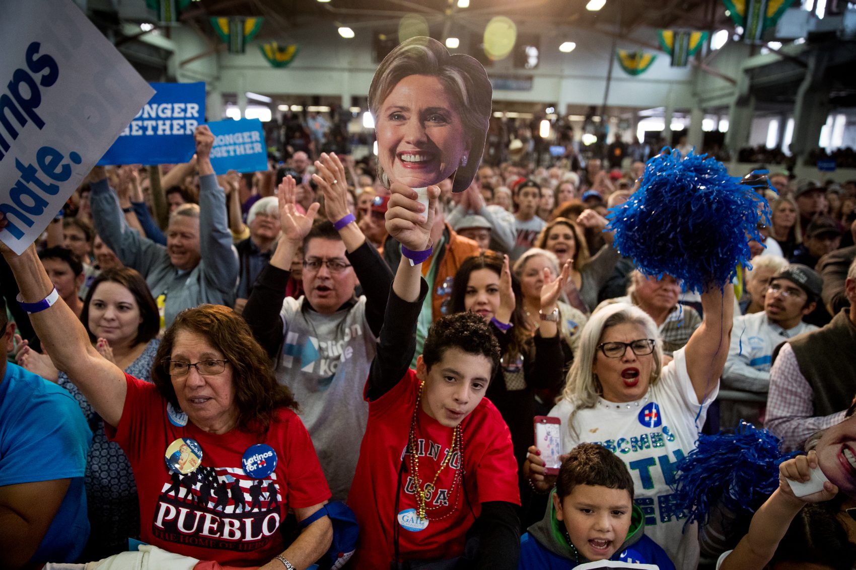 A young man in the audience holds a mask depicting Democratic presidential candidate Hillary Clinton and cheers as she speaks at a rally at the Colorado State Fairgrounds in Pueblo, Colo., Wednesday, Oct. 12, 2016. (Andrew Harnik/AP)