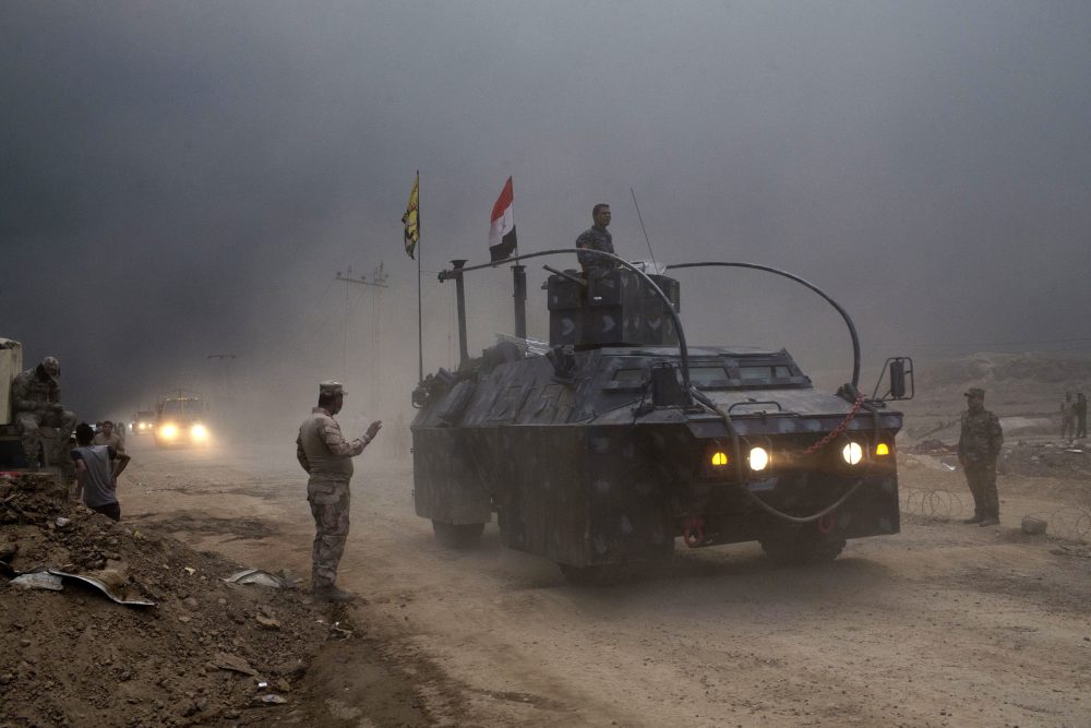 An Iraqi Federal Police vehicle passes through a checkpoint in Qayara, south of Mosul, Iraq, Wednesday, Oct. 26, 2016. Islamic State militants have been going door to door in farming communities south of Mosul, ordering people at gunpoint to follow them north into the city and apparently using them as human shields as they retreat from Iraqi forces. (Marko Drobnjakovic/AP)