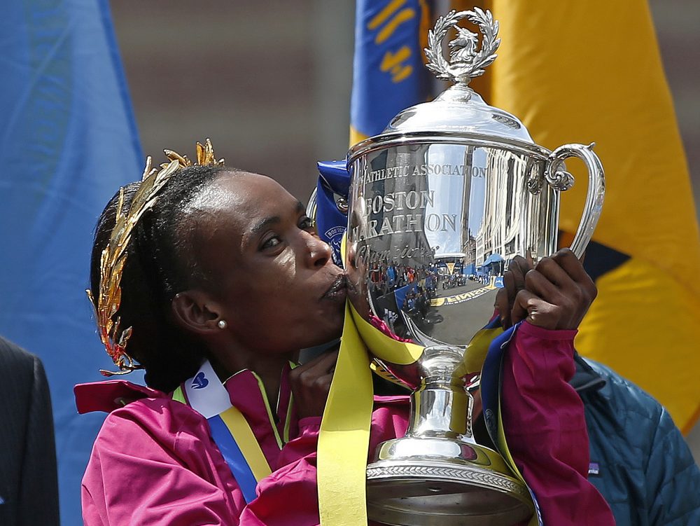 In this April 21, 2014 file photo, Rita Jeptoo of Kenya kisses the trophy after winning the women's division of the 118th Boston Marathon in Boston. On Wednesday, Jeptoo was stripped of that victory for alleged doping. (Elise Amendola/AP)