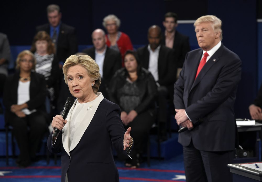 Democratic presidential nominee Hillary Clinton, left, talks as Republican presidential nominee Donald Trump listens during the second presidential debate at Washington University in St. Louis, Sunday, Oct. 9, 2016. (Saul Loeb/AP)