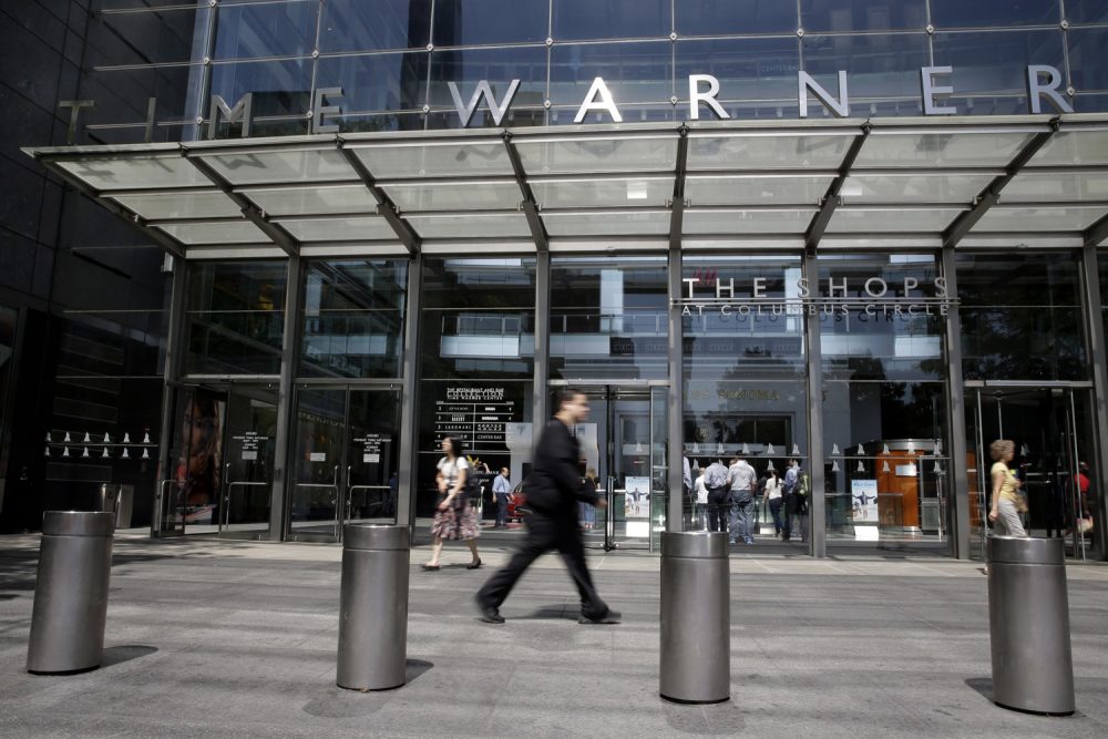 In this Tuesday, May 26, 2015 file photo, pedestrians walk by an entrance to the Time Warner Center in New York. (Mary Altaffer/AP)