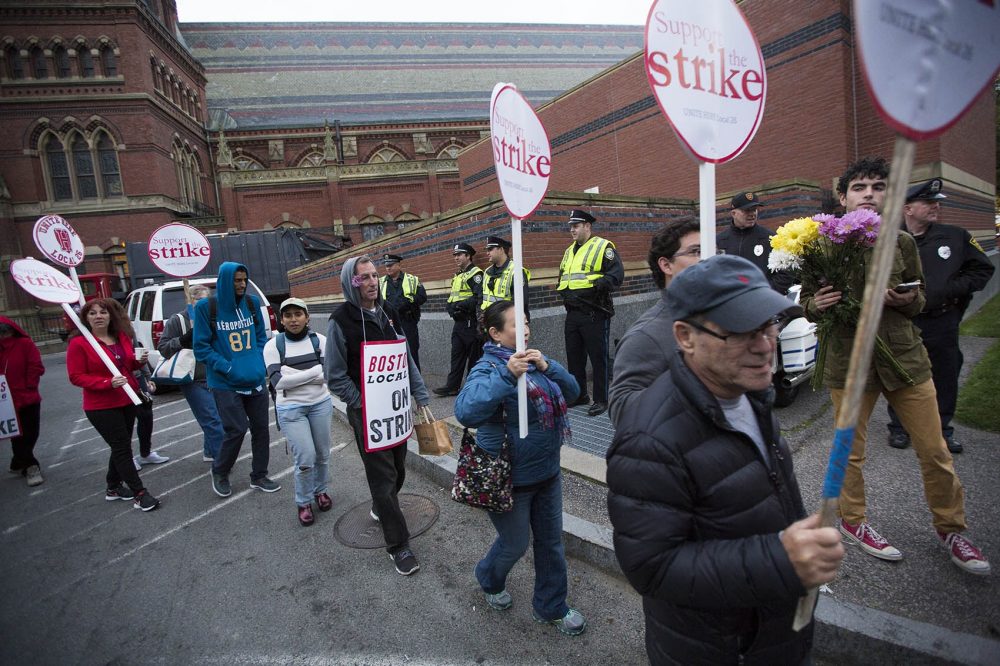 Police watch as Harvard University food service workers of the Local 26 UNITE HERE union picket peacefully outside of Memorial Hall Wednesday morning. (Jesse Costa/WBUR)