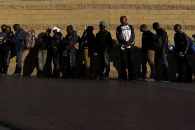 Haitian migrants line up as they wait to enter the U.S. border crossing, in Tijuana, Mexico. (Gregory Bull/AP)