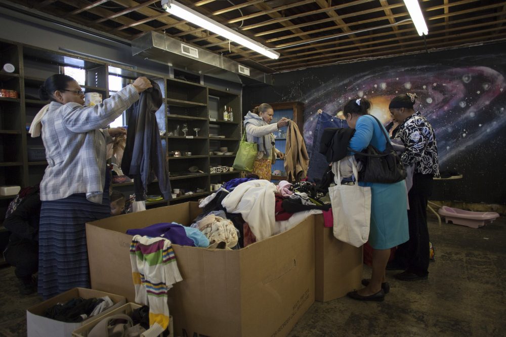 People shop at the Free Store in Worcester. Shoppers are allowed to take up to 10 items for free. (Joe Difazio for WBUR)