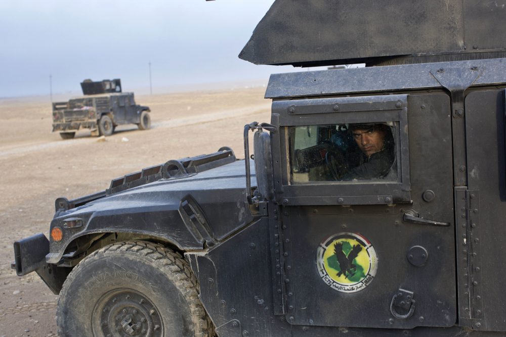 An Iraqi special forces soldier drives a Humvee close to the in the village of Bazwaya, some eight kilometers from the center of Mosul, Iraq, Monday, Oct. 31, 2016. (Marko Drobnjakovic/AP)