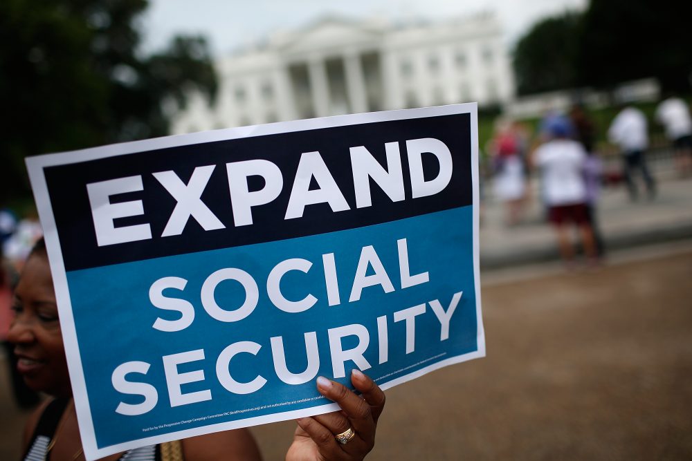 Activists participate in a rally urging the expansion of Social Security benefits in front of the White House in July 2015. (Win McNamee/Getty Images)