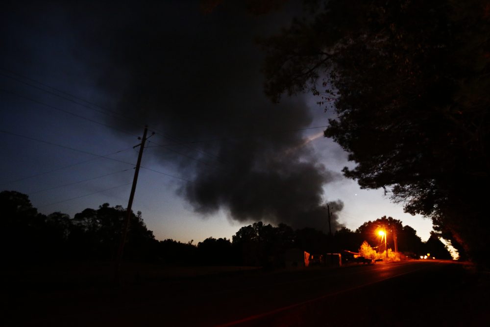 Light from a light pole shows a house near a plume of smoke from a Colonial Pipeline explosion, Monday, Oct. 31, 2016, in Helena, Ala. (Brynn Anderson/AP)