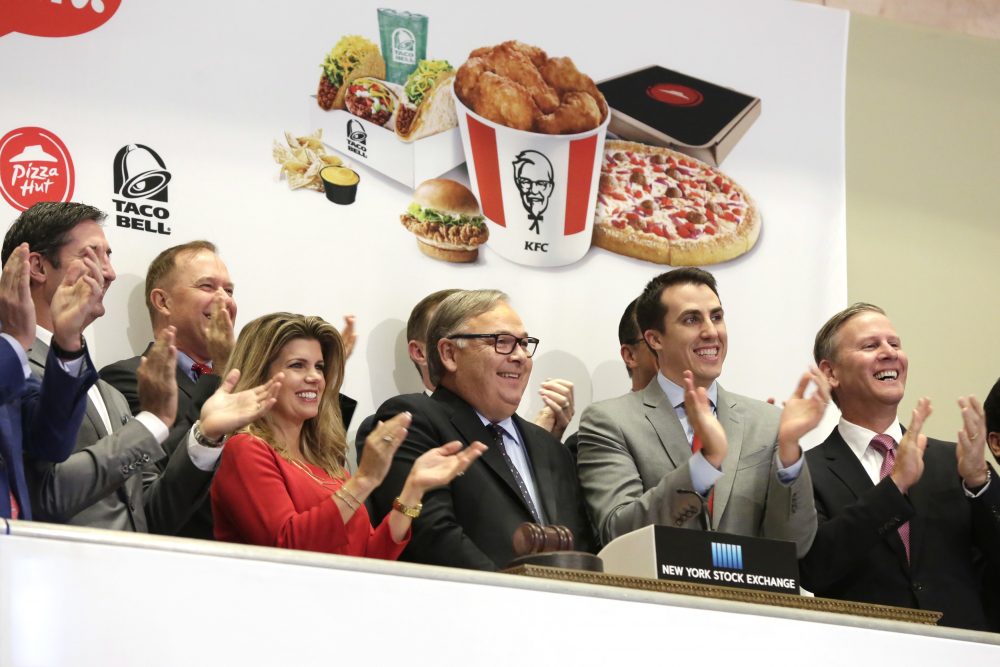 Yum Brands CEO Greg Creed, center, rings the New York Stock Exchange opening bell to mark the completion of the separation of Yum China Holdings, Inc. from Yum Brands, Tuesday, Nov. 1, 2016. (Richard Drew/AP Photo)