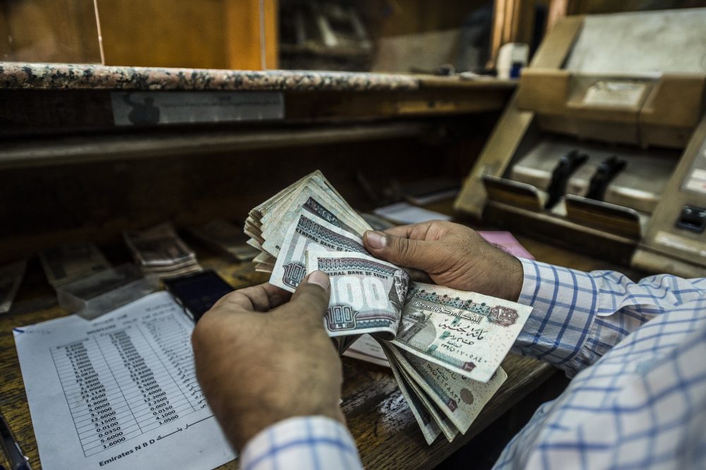 A man counts Egyptian pounds at currency exchange shop in downtown Cairo on Nov. 3, 2016. (Khaled Desouki/AFP/Getty Images)