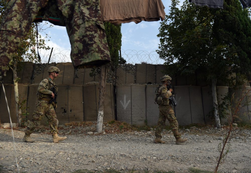 In this photograph taken on Aug. 12, 2015, US army soldiers walk past an Afghan National Army (ANA) base in the Khogyani district in the eastern province of Nangarhar. (Wakil Kohsar/AFP/Getty Images)