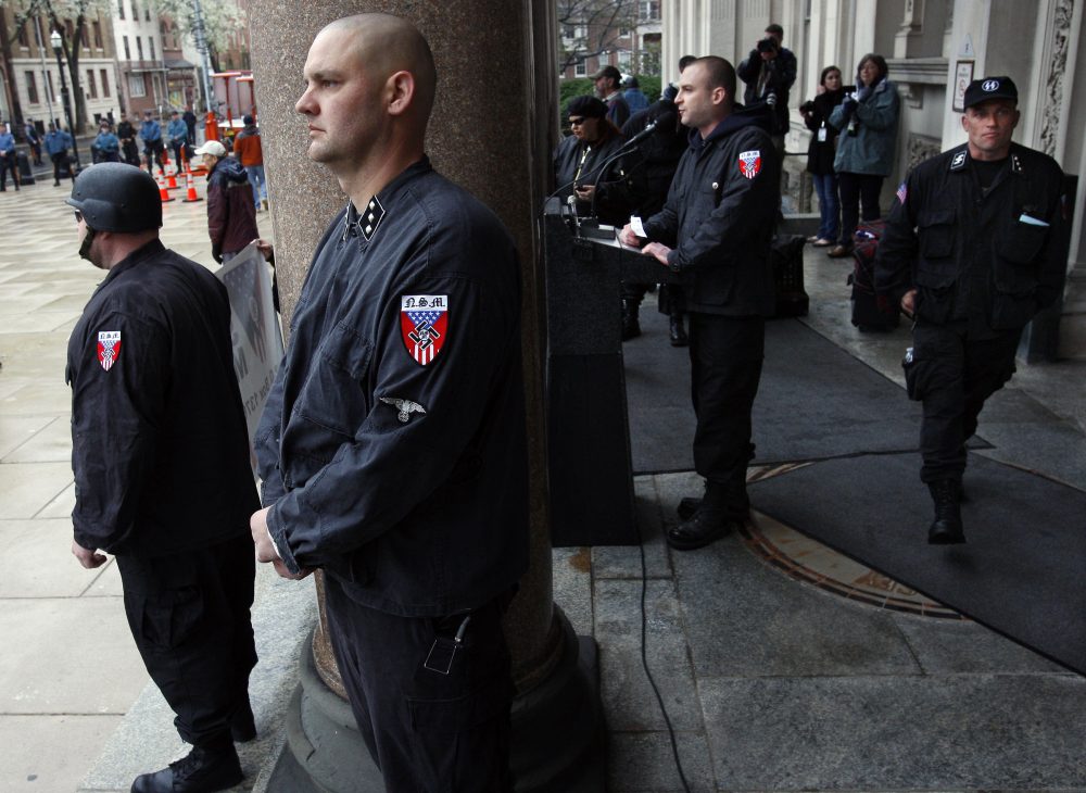 Guards of the neo-Nazi National Socialist Movement stand nearby as Commander Jeff Schoep speaks at a rally Saturday, April 16, 2011, on the steps of the statehouse in Trenton, N.J. (Mel Evans/AP)