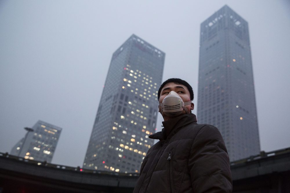 A Chinese man wears a mask to protect against pollution in heavy smog on Dec. 8, 2015 in Beijing, China. (Kevin Frayer/Getty Images)