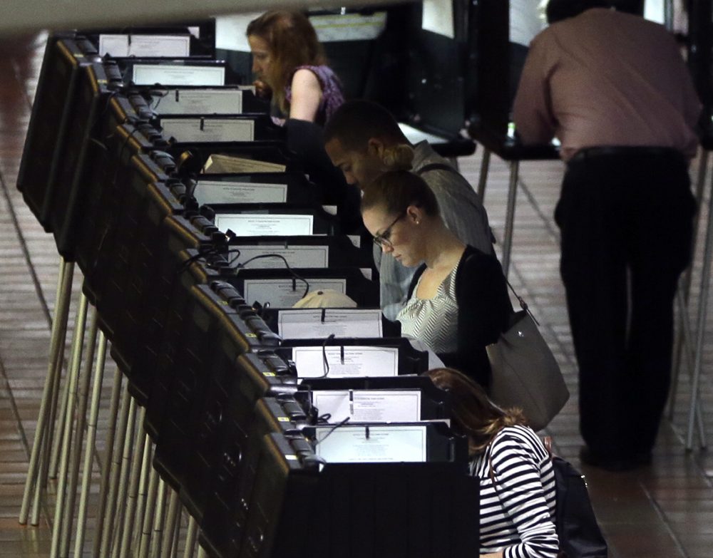 In this Oct. 24, 2016 file photo, people vote at a polling station on the first day of early voting in Miami-Dade County for the general election in Miami. Florida (Lynne Sladky/AP)