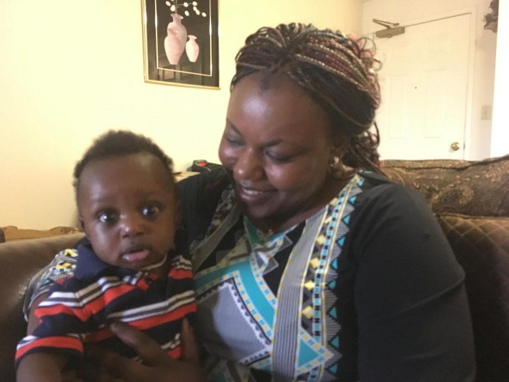 Minata Toure and her son Abdallah in the family's home on the west side of Manchester, N.H. Minata emigrated from Burkina Faso four years ago. Abdallah was born this year, in Manchester. (Natasha Haverty/NHPR)