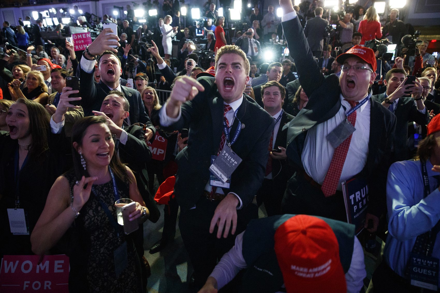 Donald Trump supporters cheer as they watch election returns Tuesday night in New York. Trump won the presidency in an upset, after a tumultuous campaign. (Evan Vucci/AP)