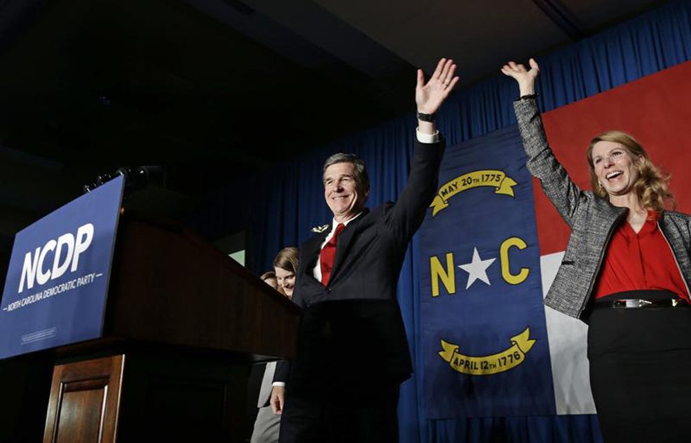 North Carolina Democratic candidate for governor Roy Cooper and his wife Kristin greet supporters during an election night rally in Raleigh, N.C., Wednesday, Nov. 9, 2016. The race between Cooper and Republican Gov. Pat McCrory remains too close to call. (Gerry Broome/AP)