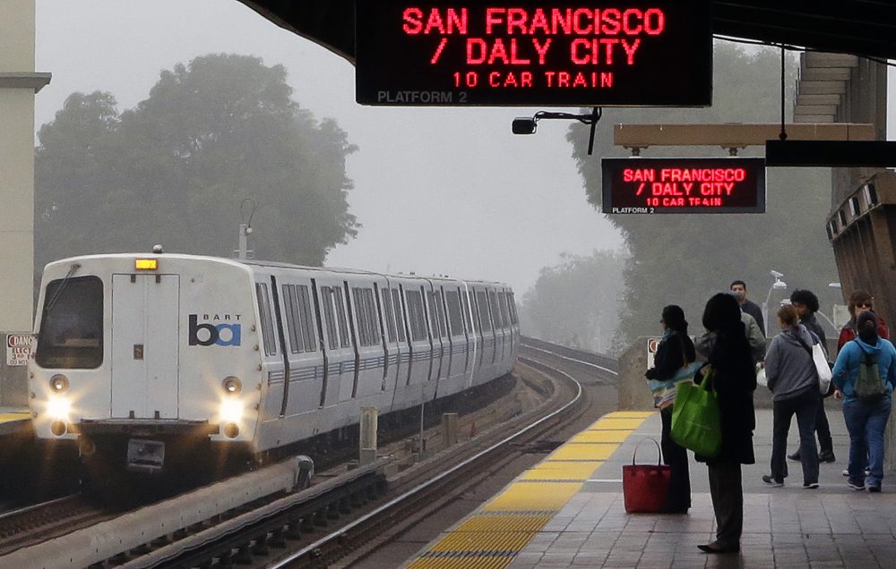 Bay Area Rapid Transit (BART) passengers wait for a train in Oakland, Calif., in October 2013. (Ben Margot/AP)