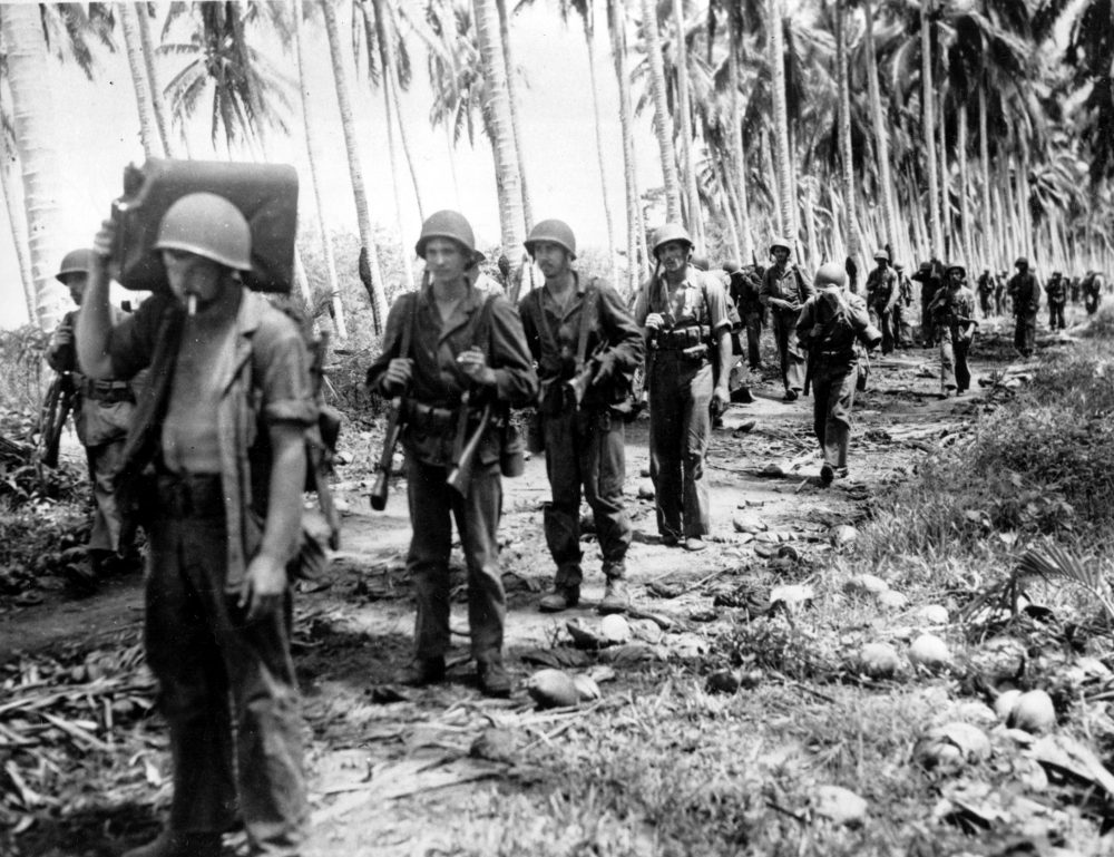 A contingent of U.S. Marines advances along a Guadalcanal jungle road toward Tassafaronga in the Solomon Islands in February 1943 during World War II. (AP)