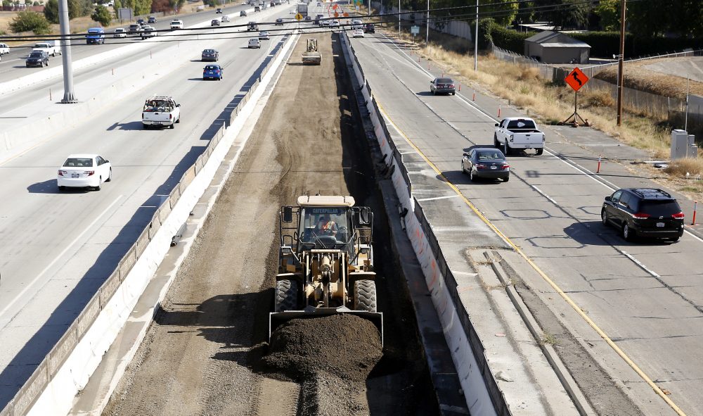 Vehicles pass a highway construction site on Interstate 80 in Sacramento, Calif., in October 2015. (Rich Pedroncelli/AP)