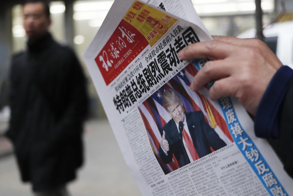 A man reads a newspaper with the headline of &quot;U.S. President-elect Donald Trump delivers a mighty shock to America&quot; at a news stand in Beijing on Nov. 10, 2016. (Andy Wong/AP)