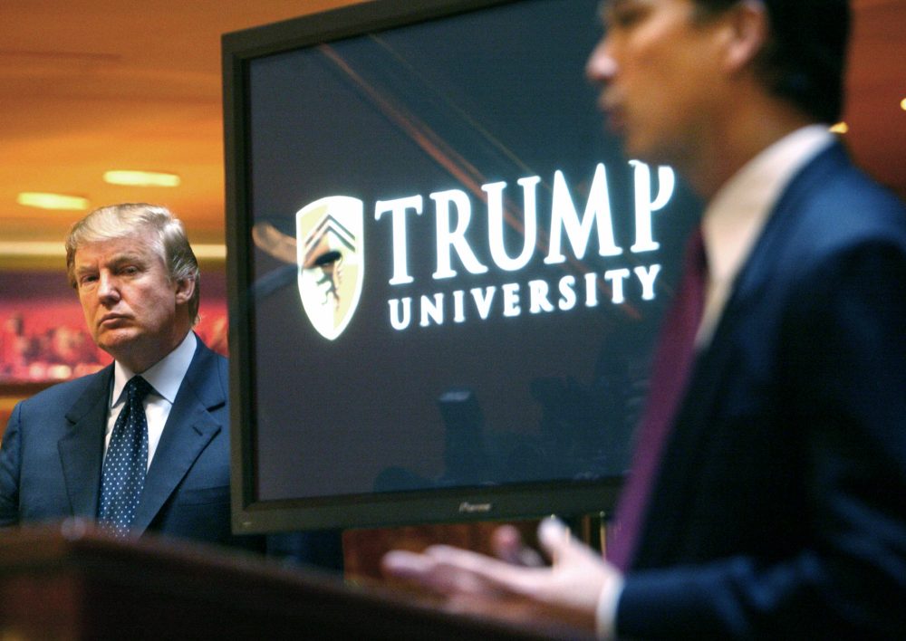 In this May 23, 2005 file photo, Donald Trump listens as Michael Sexton introduces him at a news conference in New York where he announced the establishment of Trump University. (Bebeto Matthews/AP)