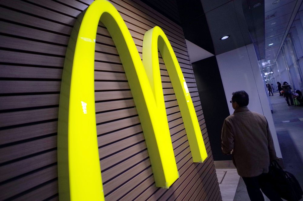 In this Dec. 17, 2014, file photo, a man walks by a McDonald's restaurant in Tokyo. (Eugene Hoshiko/AP)
