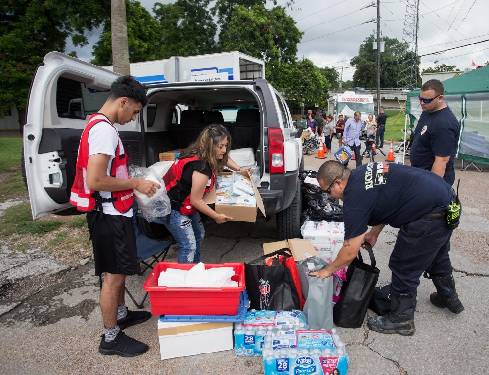 Members of the American Red Cross along with Gabe Escochea and Brett Hafer of the Richmond Fire Department prepare items for flood stricken families along the Brazos River in Richmond, Texas, in June 2016. (Bob Levey/Getty Images)