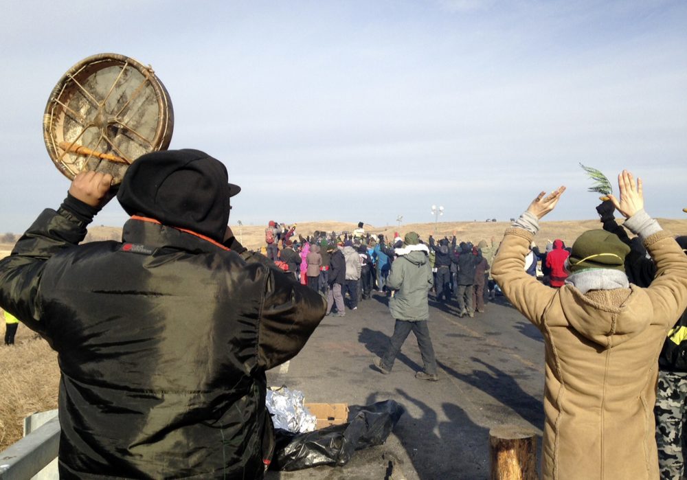 Protesters against the Dakota Access oil pipeline congregate Monday, Nov. 21, 2016, near Cannon Ball, N.D., on a long-closed bridge on a state highway near their camp in southern North Dakota. (James MacPherson/AP)