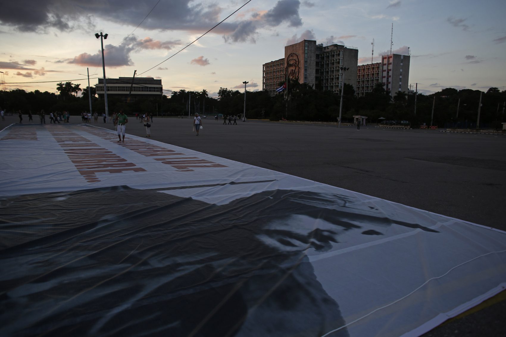 A giant banner with a photograph of the late Cuban leader Fidel Castro lies on the ground waiting to be hung at the Revolution Square in Havana, Cuba on Sunday. (Dario Lopez-Mills/AP)