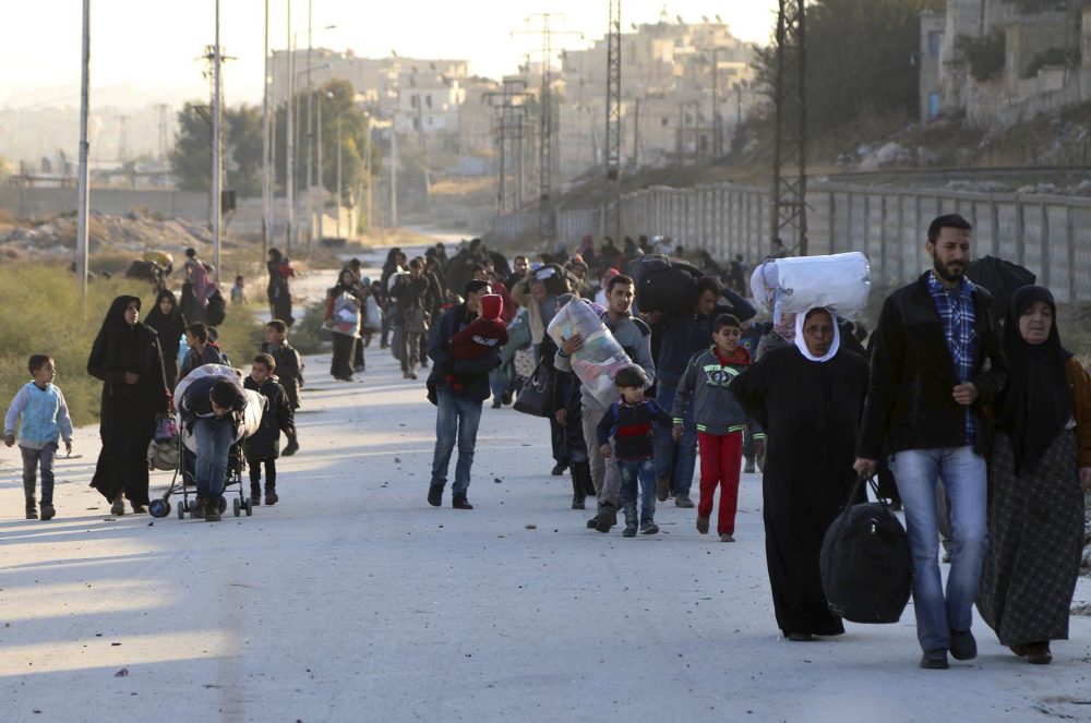 This Sunday, Nov. 27, 2016 photo provided by the Rumaf, a Syrian Kurdish activist group, which has been authenticated based on its contents and other AP reporting, shows people fleeing rebel-held eastern neighborhoods of Aleppo into the Sheikh Maqsoud area that is controlled by Kurdish fighters. (The Rumaf via AP)