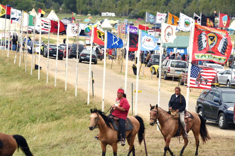Flags of Native American tribes from across the U.S. and Canada line the entrance to a protest encampment near Cannon Ball, N.D. where members of the Standing Rock Sioux Tribe and their supporters gathered to voice their opposition to the Dakota Access Pipeline (DAPL), Sept. 3, 2016. (Robyn Beck/AFP/Getty Images)