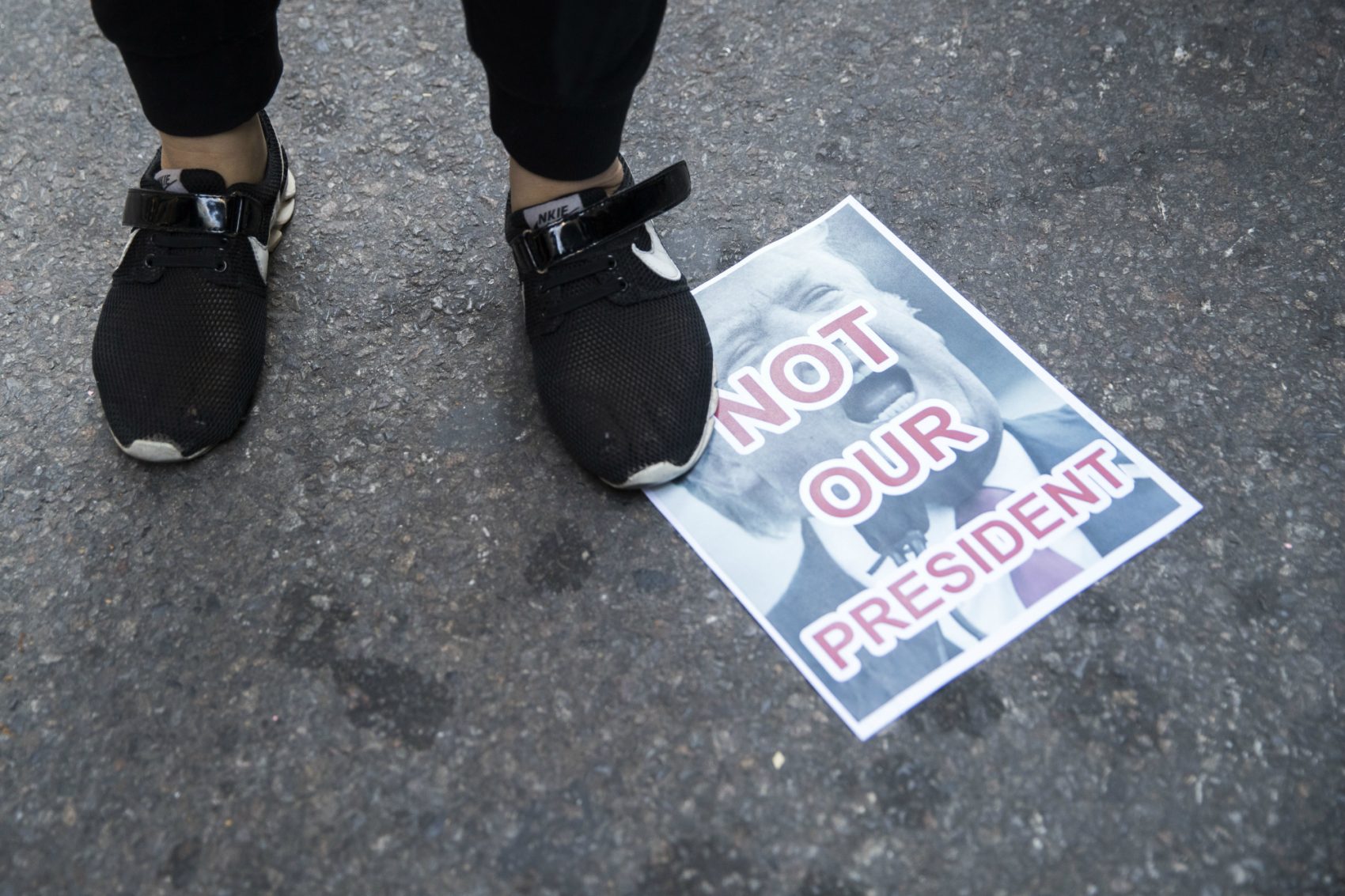 Do Americans of conscience have the energy and the will to shape themselves into a genuine and enduring protest movement?
Pictured: Protestors stands on a poster during a demonstration against the election of President-elect Donald Trump during a rally outside Trump Tower, Saturday, Nov. 12, 2016, in New York. (Mary Altaffer/AP)