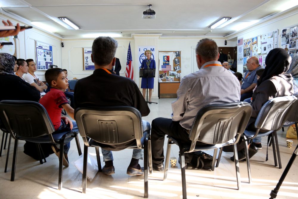 Some worry a big cut in the number of refugees the U.S. accepts each year will lead to global uncertainty. Pictured here: Three Syrian families meet with the U.S. ambassador to Jordan ahead of their departure to the U.S. earlier this year. (Raad Adayleh/AP/File)