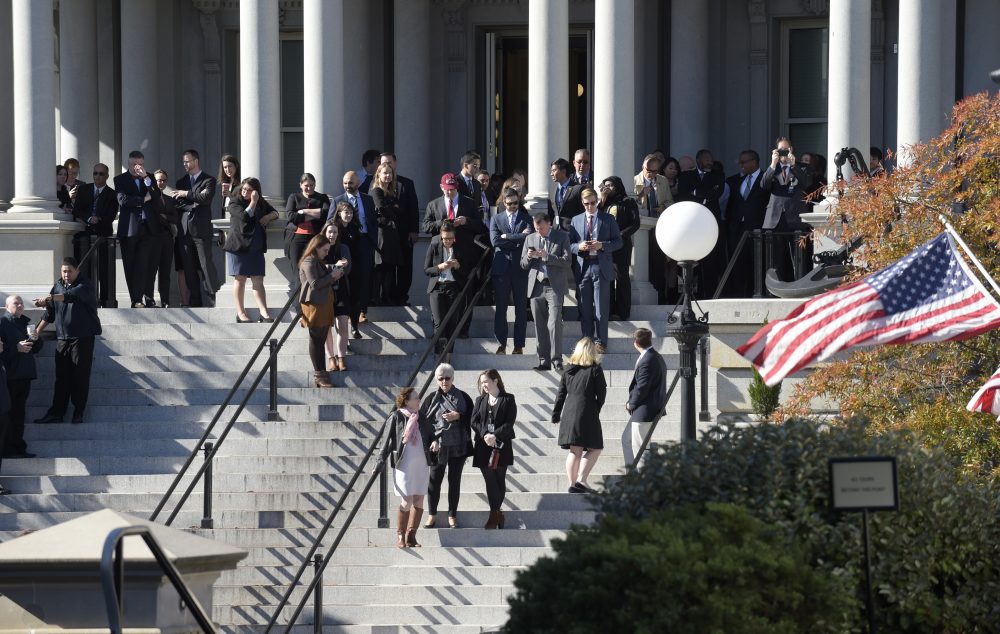 People stand on the steps of the Eisenhower Executive Office Building, next to the White House on Thursday, Nov. 10, 2016, as they wait for the arrival of President-elect Donald Trump for his meeting with President Barack Obama. (Susan Walsh/AP)