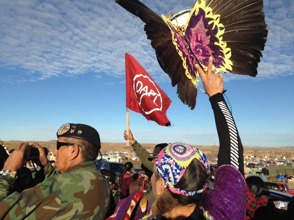In these times, writes Frederick Hewett, social justice groups need to seek out linkages between their respective missions...even if it means other causes may momentarily overshadow their own. Pictured: Demonstrators against the Dakota Access oil pipeline hold a ceremony at the main protest camp Tuesday, Nov. 15, 2016, near Cannon Ball, North Dakota. (James MacPherson/AP)